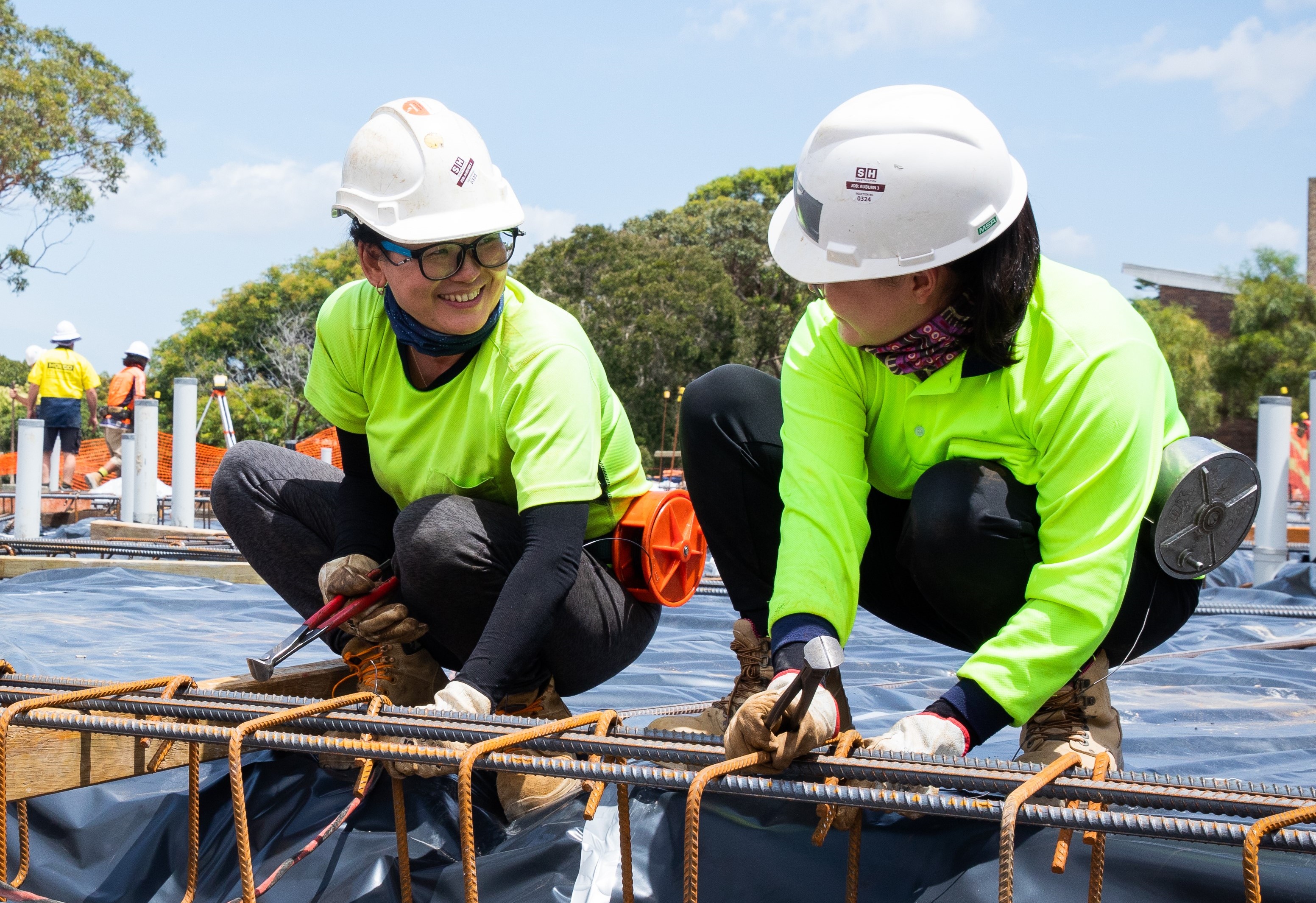 Female construction workers smiling at each other_NSW Treasury Copyright_Image Credit Renee Nowytarger